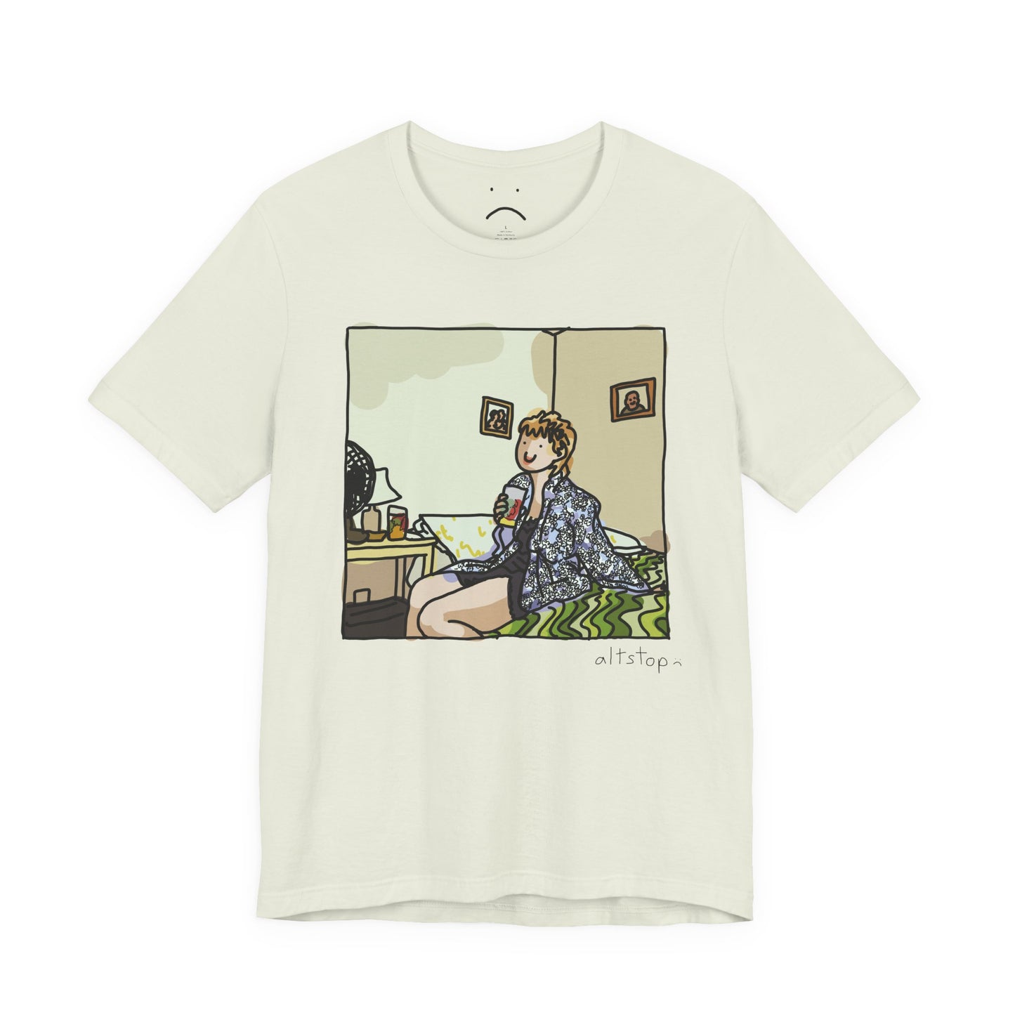 gorl with a cup on a bed deluxe tee